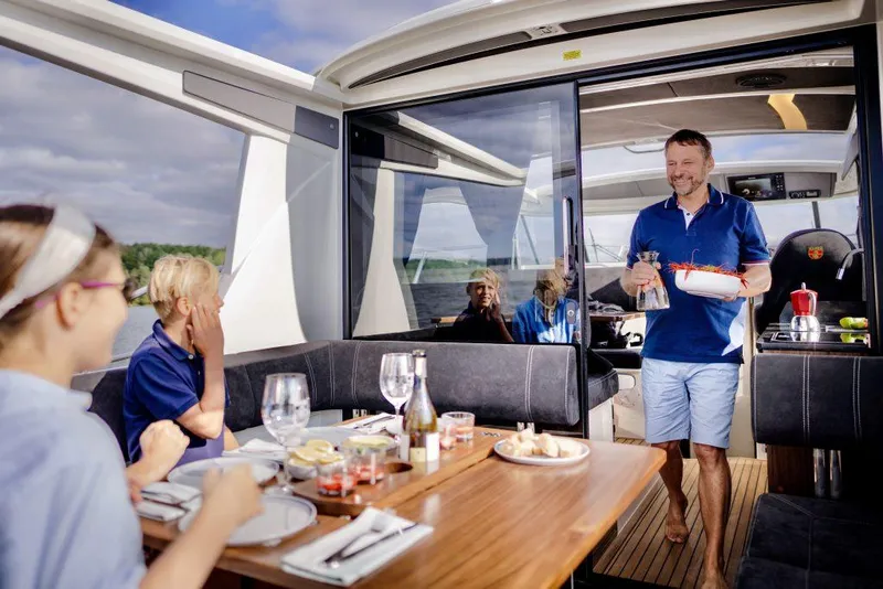 Slide: The Image of Family dining on 2025 Marex 330 Scandinavia yacht, enjoying a meal on deck. - 29