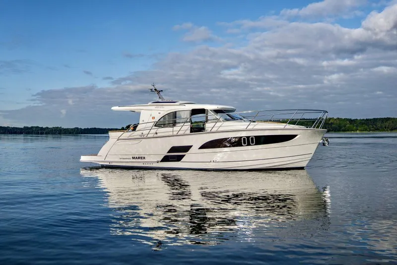 Slide: The Image of 2025 Marex 330 Scandinavia yacht on calm water under a partly cloudy sky. - 3