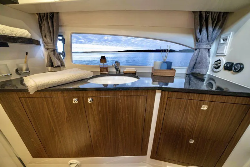 Slide: The Image of Luxurious Marex 330 Scandinavia 2025 yacht interior with wooden cabinets and ocean view. - 35