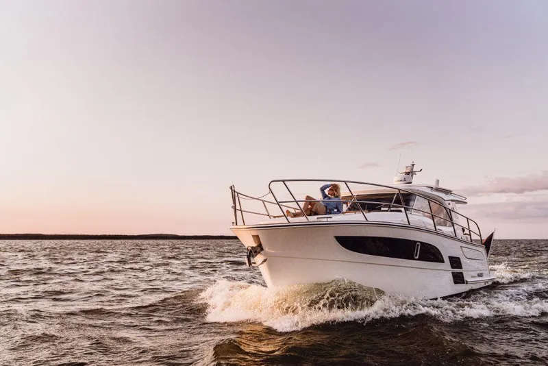 Slide: The Image of 2025 Marex 330 Scandinavia yacht cruising on open water at sunset. - 44