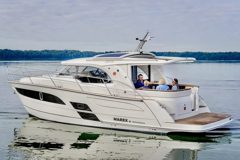 Slide: The Image of 2025 Marex 330 Scandinavia yacht cruising on calm waters with passengers onboard. - 45