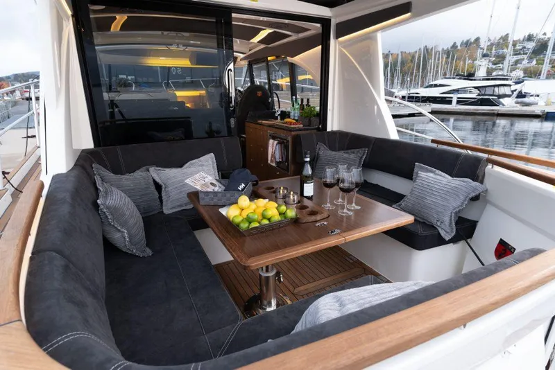 Slide: The Image of Luxurious Marex 330 Scandinavia yacht interior with cozy seating and elegant table setting. - 47