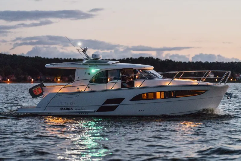 Slide: The Image of 2025 Marex 330 Scandinavia yacht cruising at sunset on a calm lake. - 9