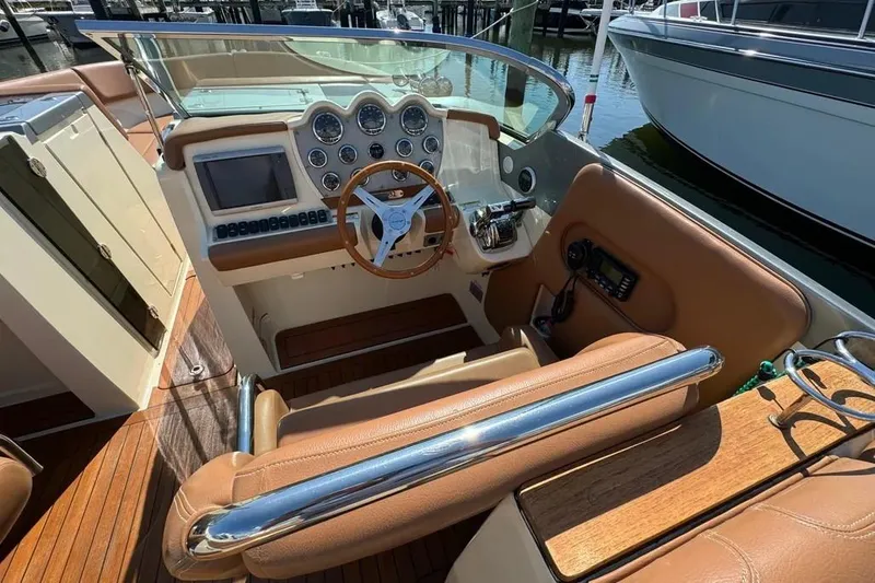 Slide: The Image of 2013 Chris-Craft Launch 32 cockpit with leather seats and wooden steering wheel. - 21