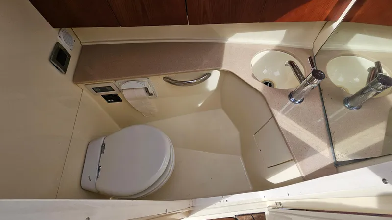 Slide: The Image of 2013 Chris-Craft Launch 32 boat bathroom with toilet, sink, and countertop. - 22