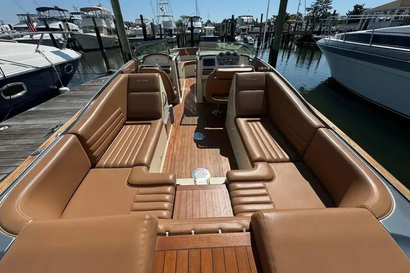 Slide: The Image of 2013 Chris-Craft Launch 32 with luxurious brown leather seating at a marina. - 6