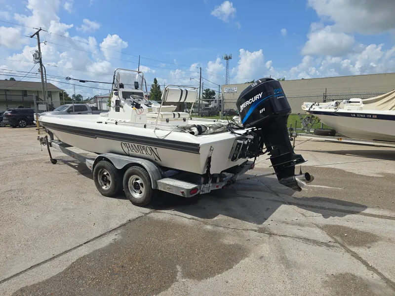 Slide: The Image of 2000 Champion 21 Bay Champ boat with Mercury outboard motor on a trailer. - 4