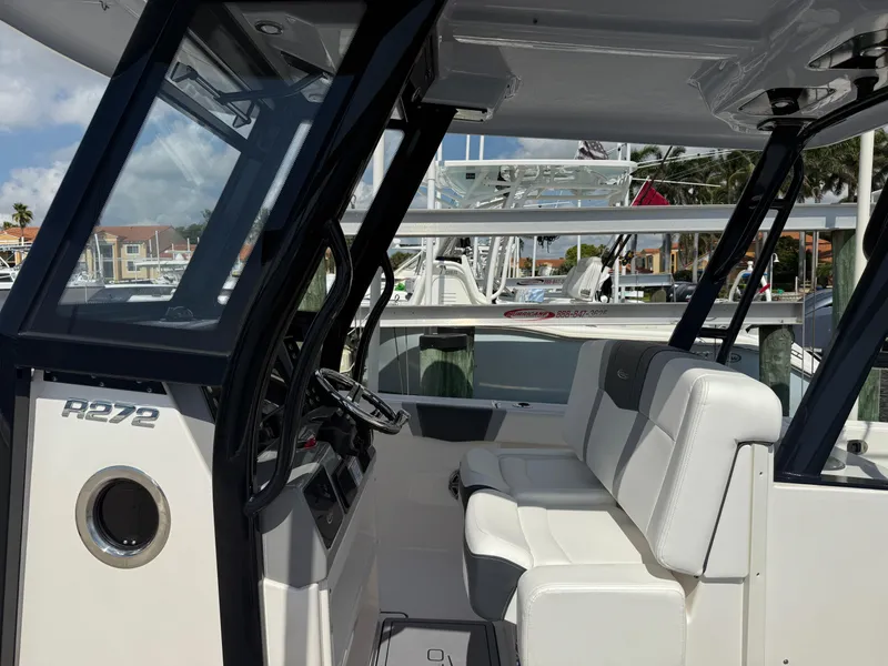 Slide: The Image of 2023 Robalo R272 Center Console boat interior with seating and helm. - 10