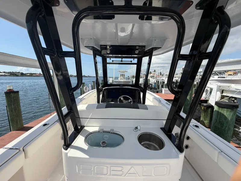 Slide: The Image of 2023 Robalo R272 Center Console boat interior with helm and seating area. - 14