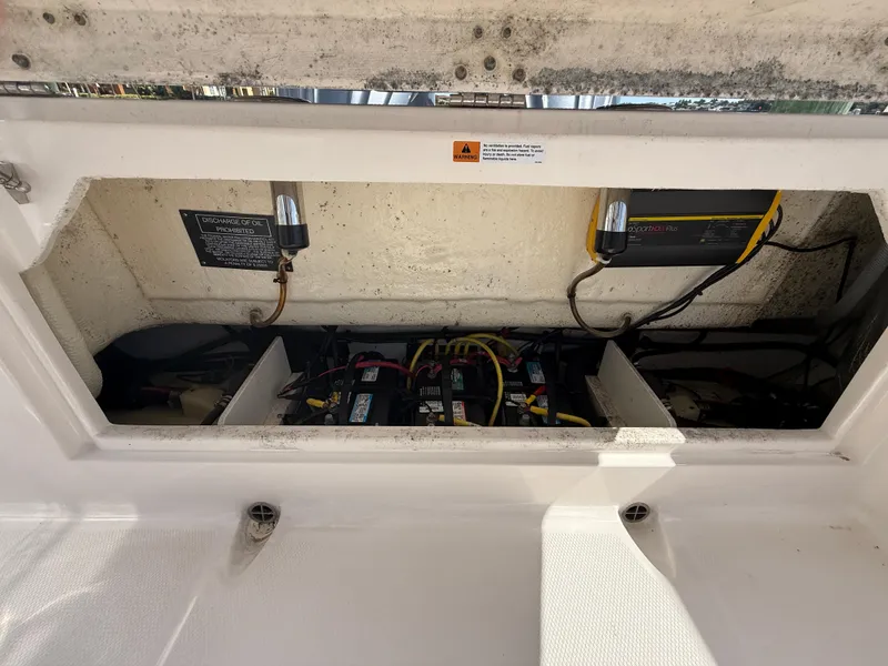 Slide: The Image of 2023 Robalo R272 Center Console battery compartment with wiring and components. - 20