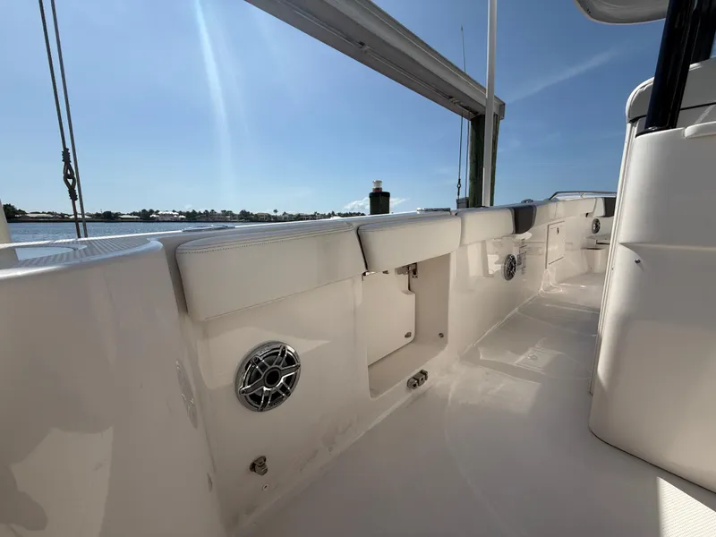 Slide: The Image of 2023 Robalo R272 Center Console boat interior with sleek white design and waterfront view. - 23