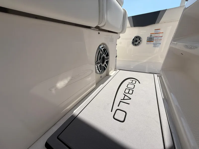 Slide: The Image of 2023 Robalo R272 Center Console interior with branded mat and speaker. - 27