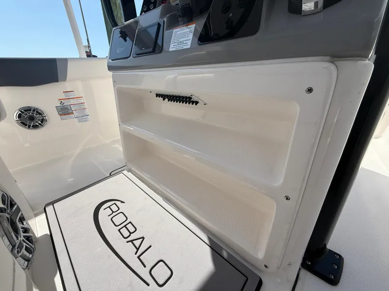 Slide: The Image of 2023 Robalo R272 Center Console interior with storage and branded mat. - 28