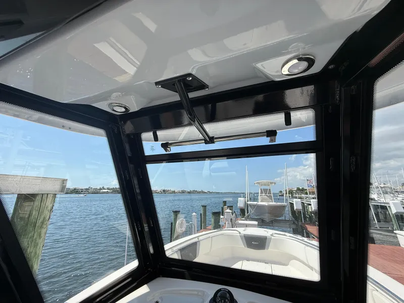 Slide: The Image of 2023 Robalo R272 Center Console boat interior with waterfront view. - 29