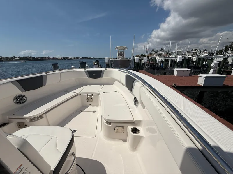 Slide: The Image of 2023 Robalo R272 Center Console boat docked at marina under clear sky. - 30