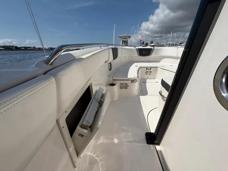 Slide: The Image of 2023 Robalo R272 Center Console boat interior with sleek seating and storage. - 32