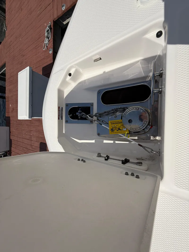 Slide: The Image of 2023 Robalo R272 Center Console anchor compartment with winch mechanism. - 35