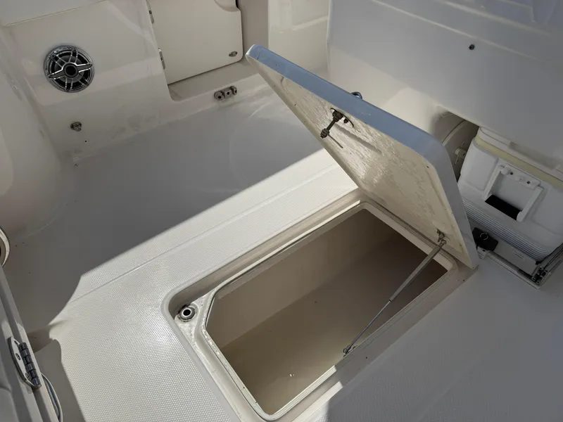 Slide: The Image of 2023 Robalo R272 Center Console boat with open storage compartment. - 38
