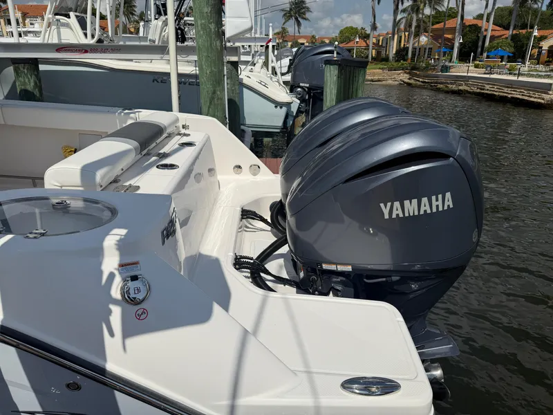 Slide: The Image of 2023 Robalo R272 Center Console with Yamaha engines docked by the water. - 5