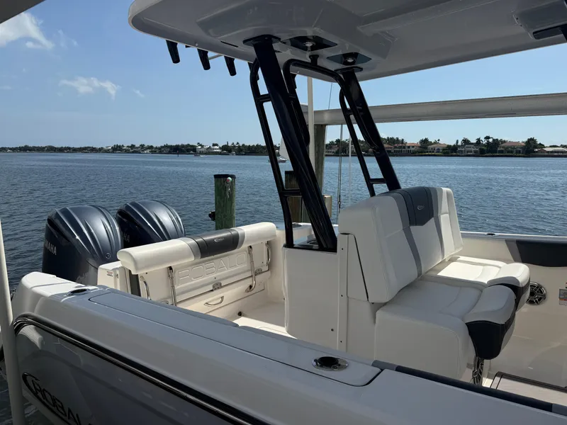 Slide: The Image of 2023 Robalo R272 Center Console boat with dual engines on a sunny day. - 7
