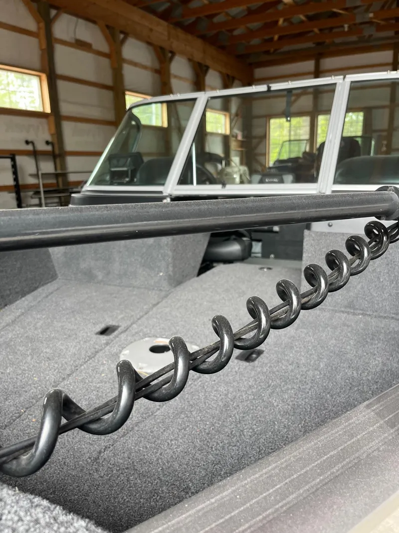 Slide: The Image of 2019 Lund 1775 Adventure Sport boat interior in a wooden garage. - 3