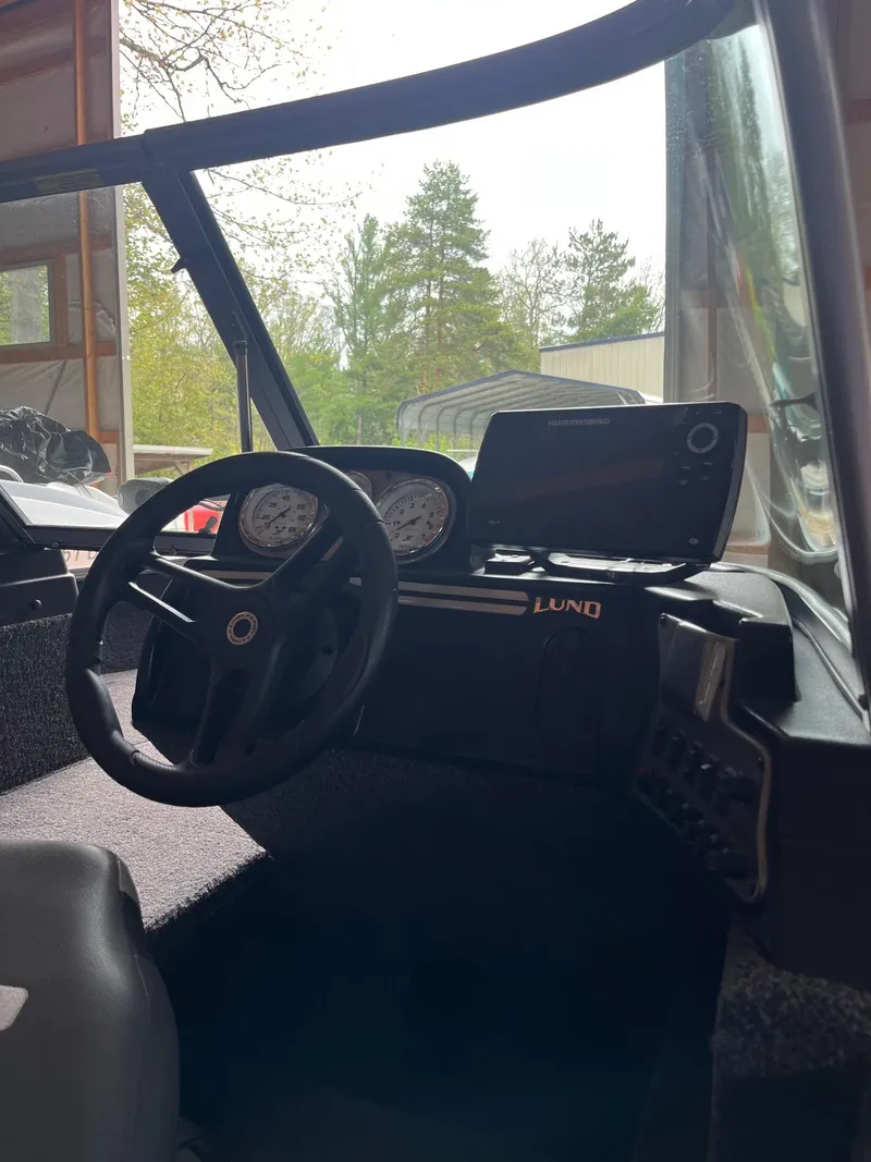 Slide: The Image of 2019 Lund 1775 Adventure Sport boat dashboard with steering wheel and gauges. - 7