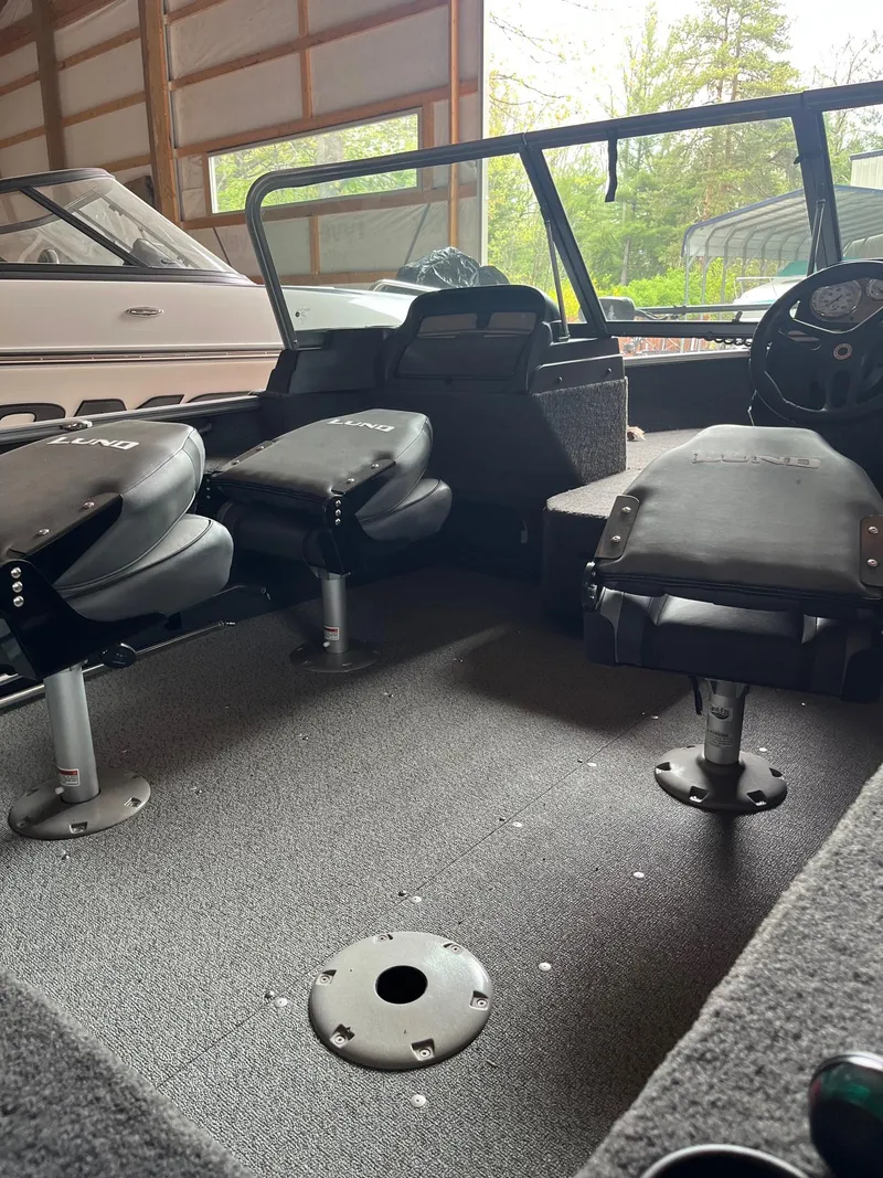 Slide: The Image of 2019 Lund 1775 Adventure Sport boat interior with seating and steering console. - 8