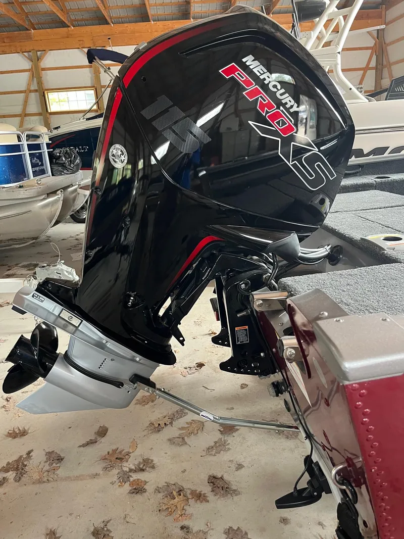 Slide: The Image of 2019 Lund 1775 Adventure Sport with Mercury Pro XS outboard motor in a storage facility. - 9