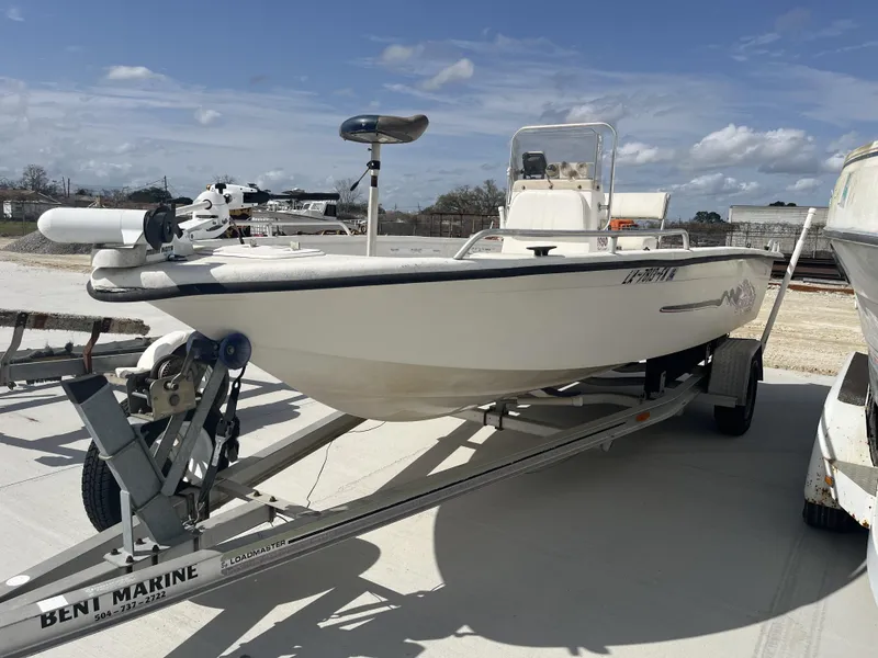 Slide: The Image of 2004 Sea Chaser 1950 Roll Gunnel boat on trailer under clear sky. - 1