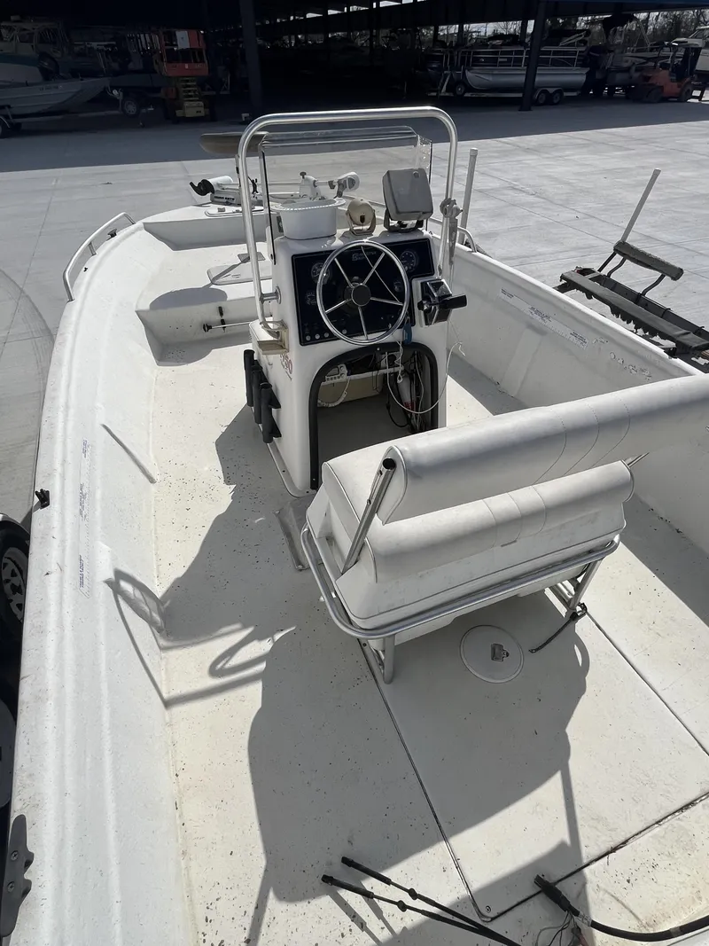 Slide: The Image of 2004 Sea Chaser 1950 Roll Gunnel boat interior with steering console and seating. - 2
