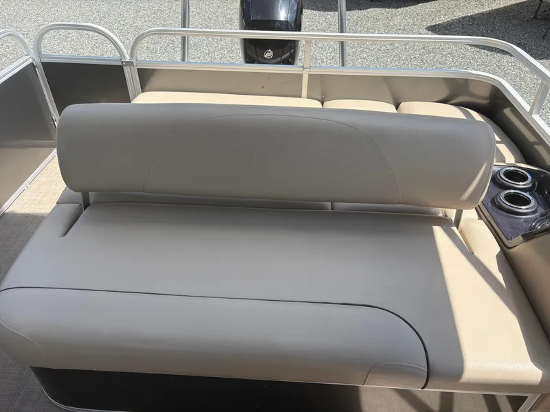 Slide: The Image of 2022 Sun Tracker Party Barge 24 DLX with beige seating and cup holders. - 11