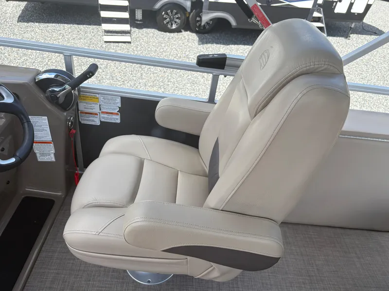 Slide: The Image of 2022 Sun Tracker Party Barge 24 DLX captain's chair, beige upholstery, boat steering console. - 12