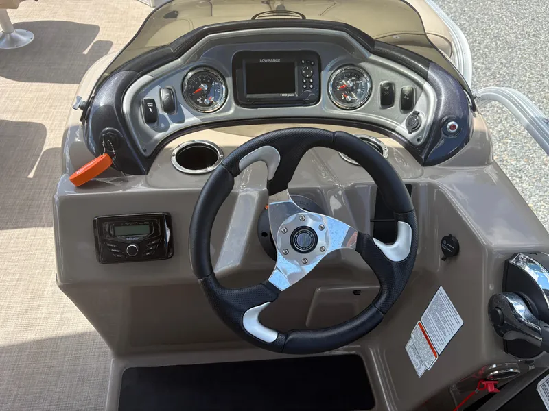 Slide: The Image of Steering console of 2022 Sun Tracker Party Barge 24 DLX with gauges and controls. - 13