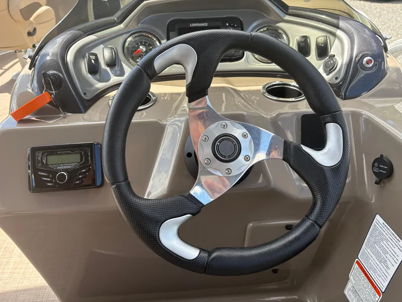 Slide: The Image of Steering wheel and dashboard of 2022 Sun Tracker Party Barge 24 DLX pontoon boat. - 16