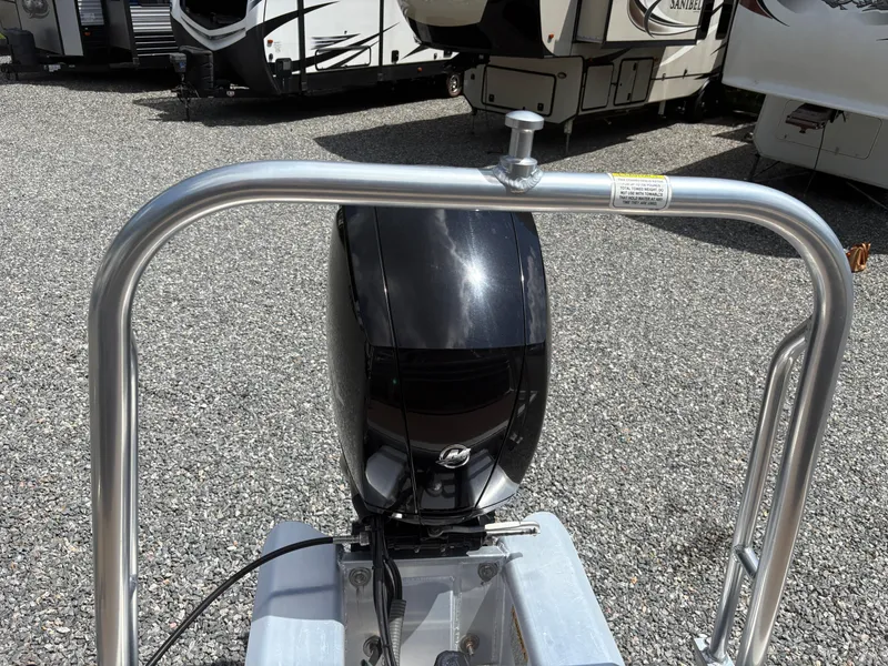 Slide: The Image of 2022 Sun Tracker Party Barge 24 DLX motor and railing in a parking lot. - 20