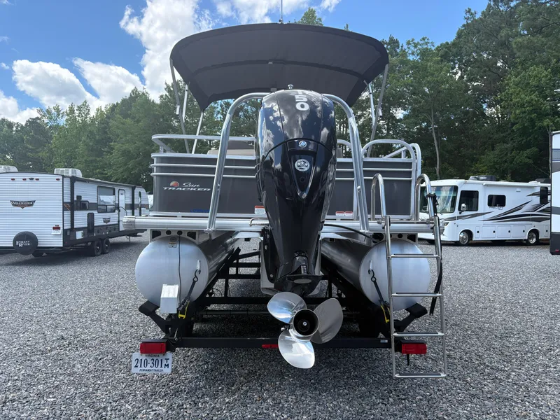 Slide: The Image of 2022 Sun Tracker Party Barge 24 DLX pontoon boat in a parking lot with RVs. - 3