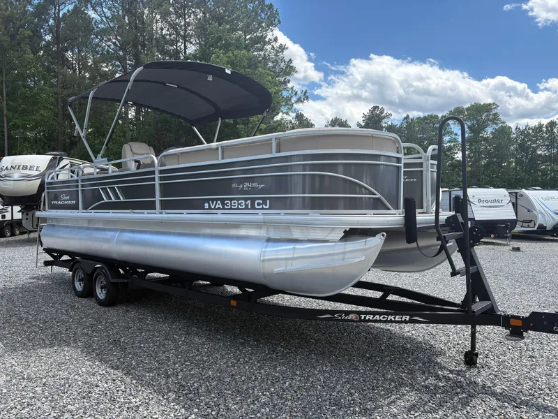 Slide: The Image of 2022 Sun Tracker Party Barge 24 DLX pontoon boat on trailer, parked outdoors. - 5