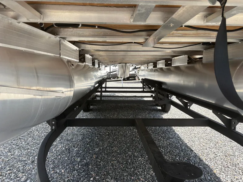 Slide: The Image of Underneath view of 2022 Sun Tracker Party Barge 24 DLX pontoon boat on gravel. - 6