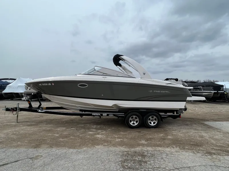 Slide: The Image of 2017 Regal 2700 boat on trailer under cloudy sky. - 10