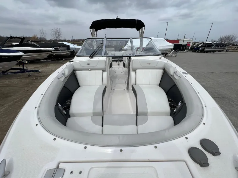 Slide: The Image of 2017 Regal 2700 boat with spacious seating, docked under cloudy skies. - 4
