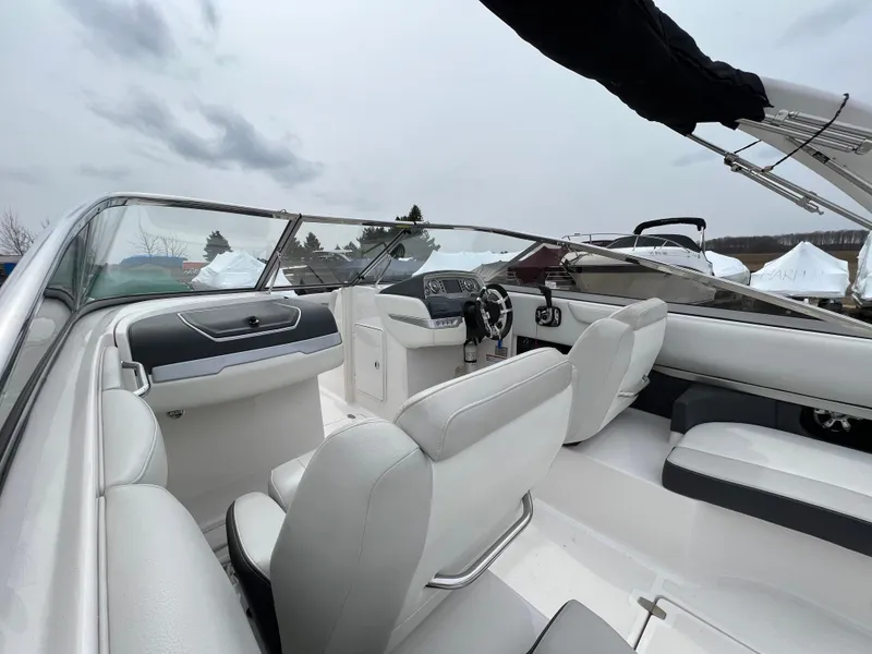 Slide: The Image of 2017 Regal 2700 boat interior with white seating and modern dashboard. - 5