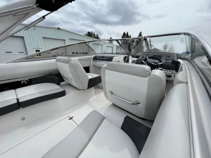 Slide: The Image of 2017 Regal 2700 boat interior with white seating and modern dashboard. - 6