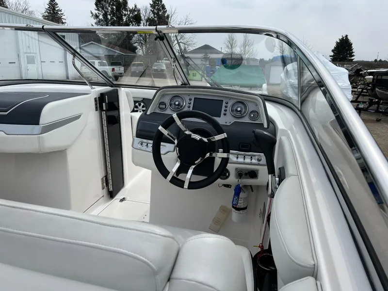 Slide: The Image of 2017 Regal 2700 boat interior with steering wheel and dashboard controls. - 7