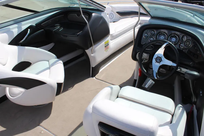 Slide: The Image of Interior of a 2012 Crownline 21 SS boat with white seating and dashboard. - 11
