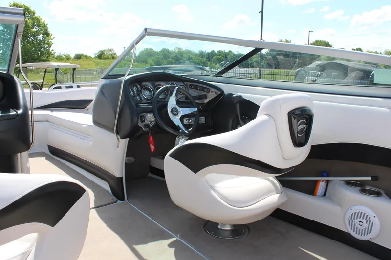 Slide: The Image of Interior of 2012 Crownline 21 SS boat with sleek white and black seating. - 14