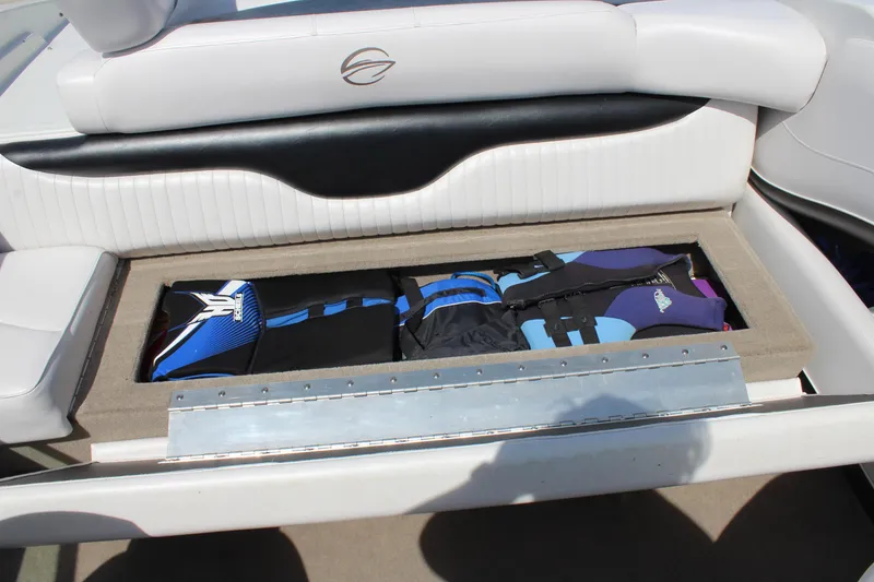 Slide: The Image of 2012 Crownline 21 SS boat storage compartment with life jackets and gear. - 16