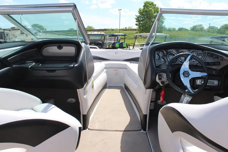 Slide: The Image of Interior of 2012 Crownline 21 SS boat with steering wheel and seating. - 18