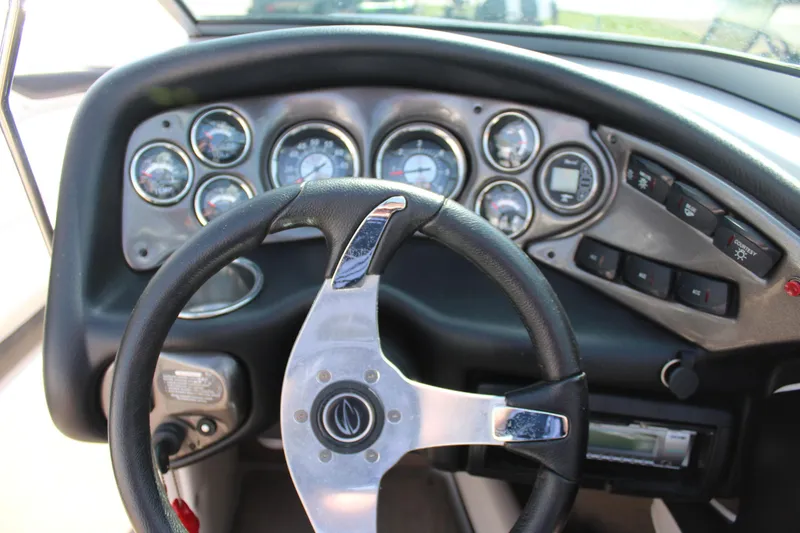 Slide: The Image of 2012 Crownline 21 SS boat dashboard with steering wheel and instrument panel. - 19