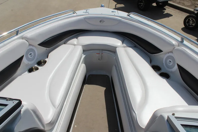 Slide: The Image of 2012 Crownline 21 SS boat interior with white seating and cup holders. - 21
