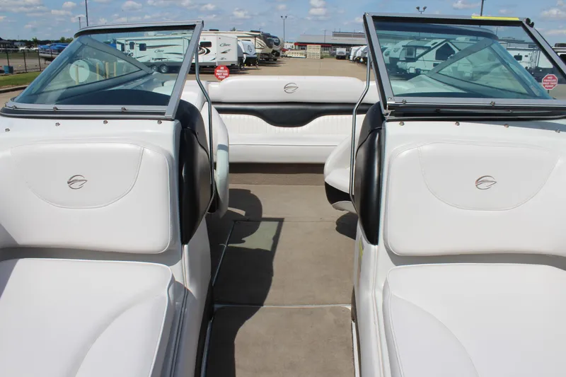 Slide: The Image of 2012 Crownline 21 SS boat interior with white seating and open deck layout. - 23